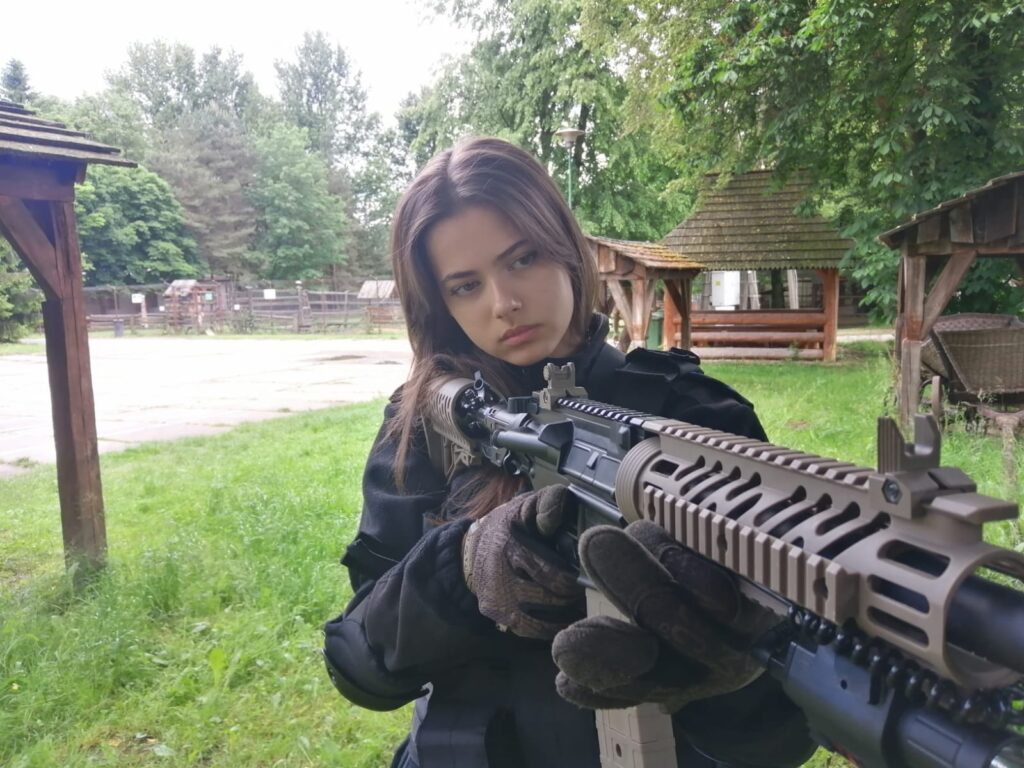Uczestniczka oboza z karabinkiem M4